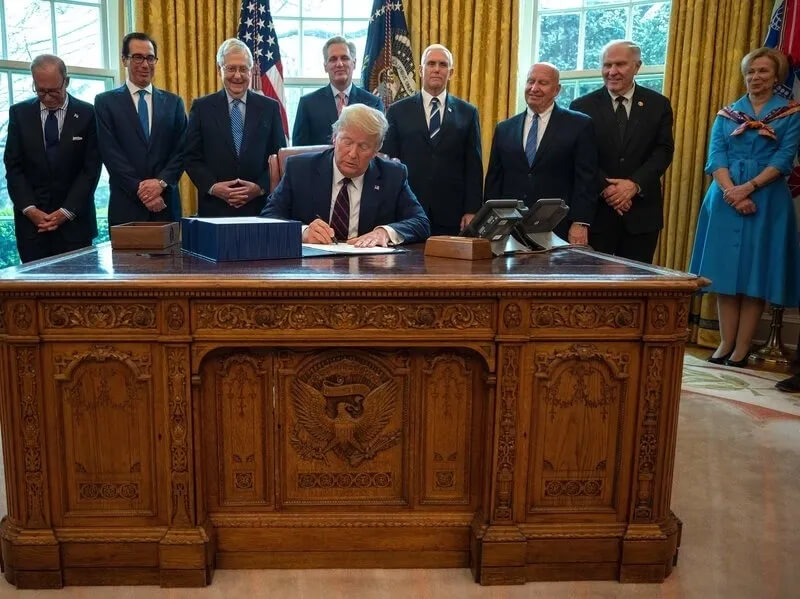 Donald Trump signing the CARES Act