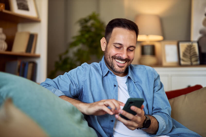 man happy having conversation on mobile at PCS